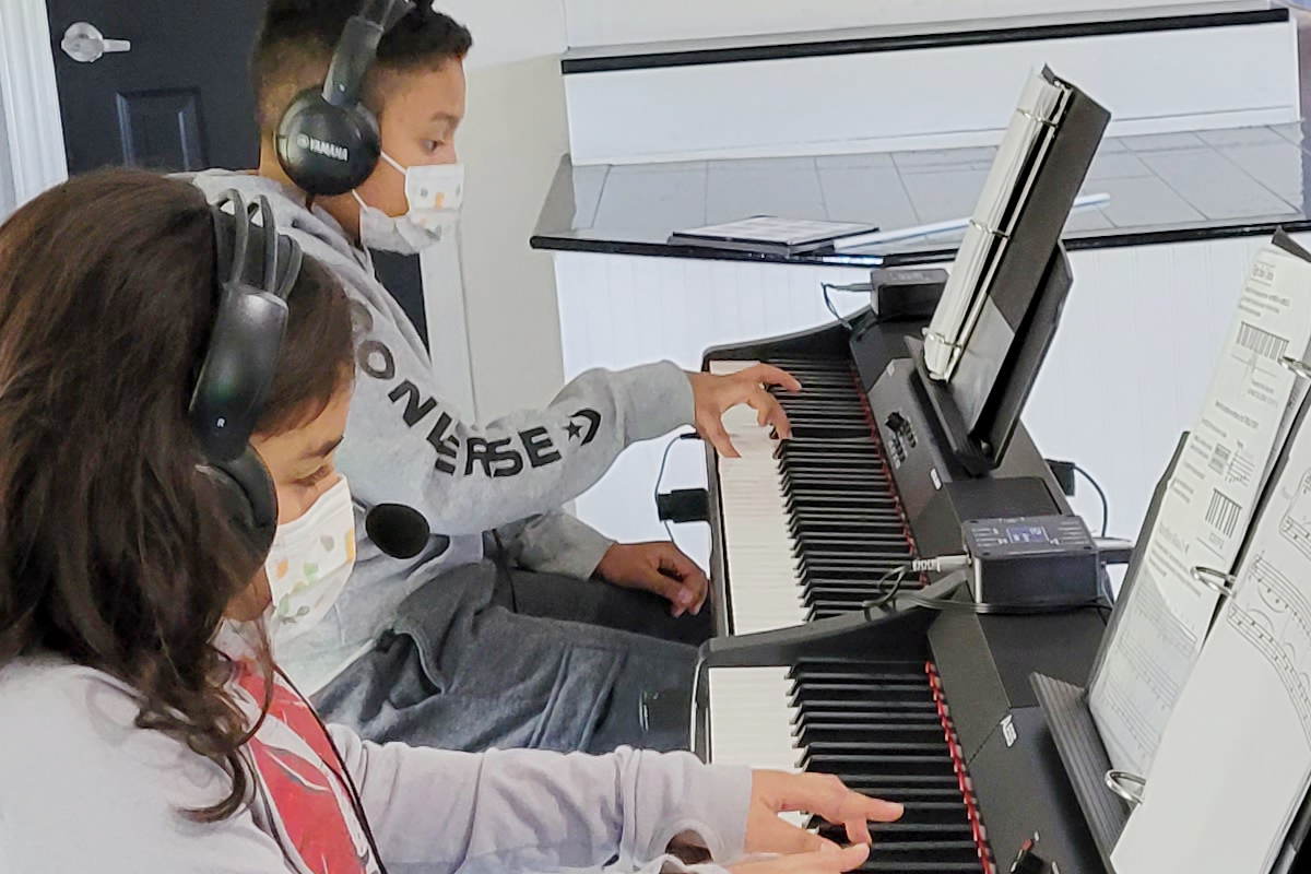 boy and girl playing piano