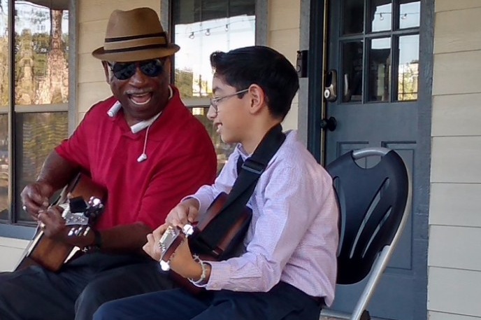 student learning to play guitar